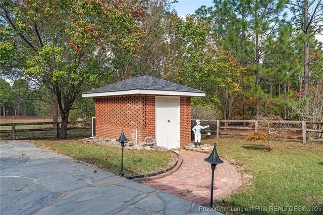 a view of a field with trees in the background