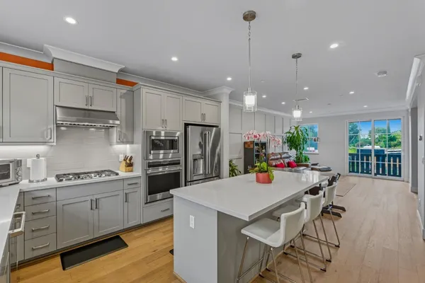 a kitchen with a table chairs refrigerator and microwave