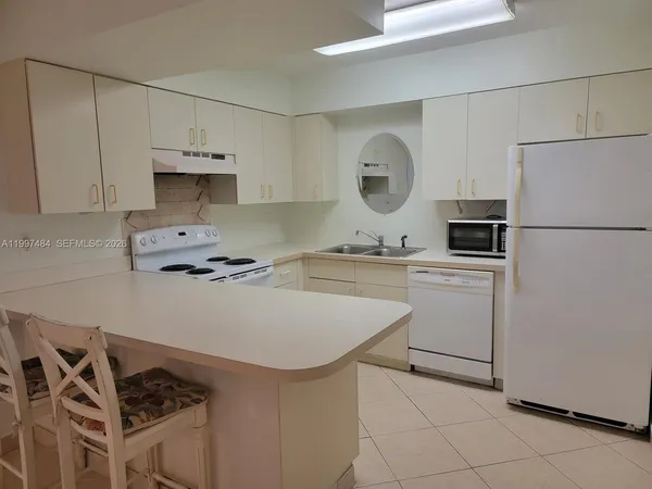 a kitchen with a sink appliances and cabinets