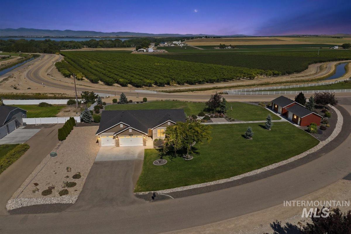 13496 Hockberger Ranch Road Caldwell, ID 83607 - Photo 40 of 40 Ranch-style residence featuring a two-car garage, mature landscaping, and an expansive lawn