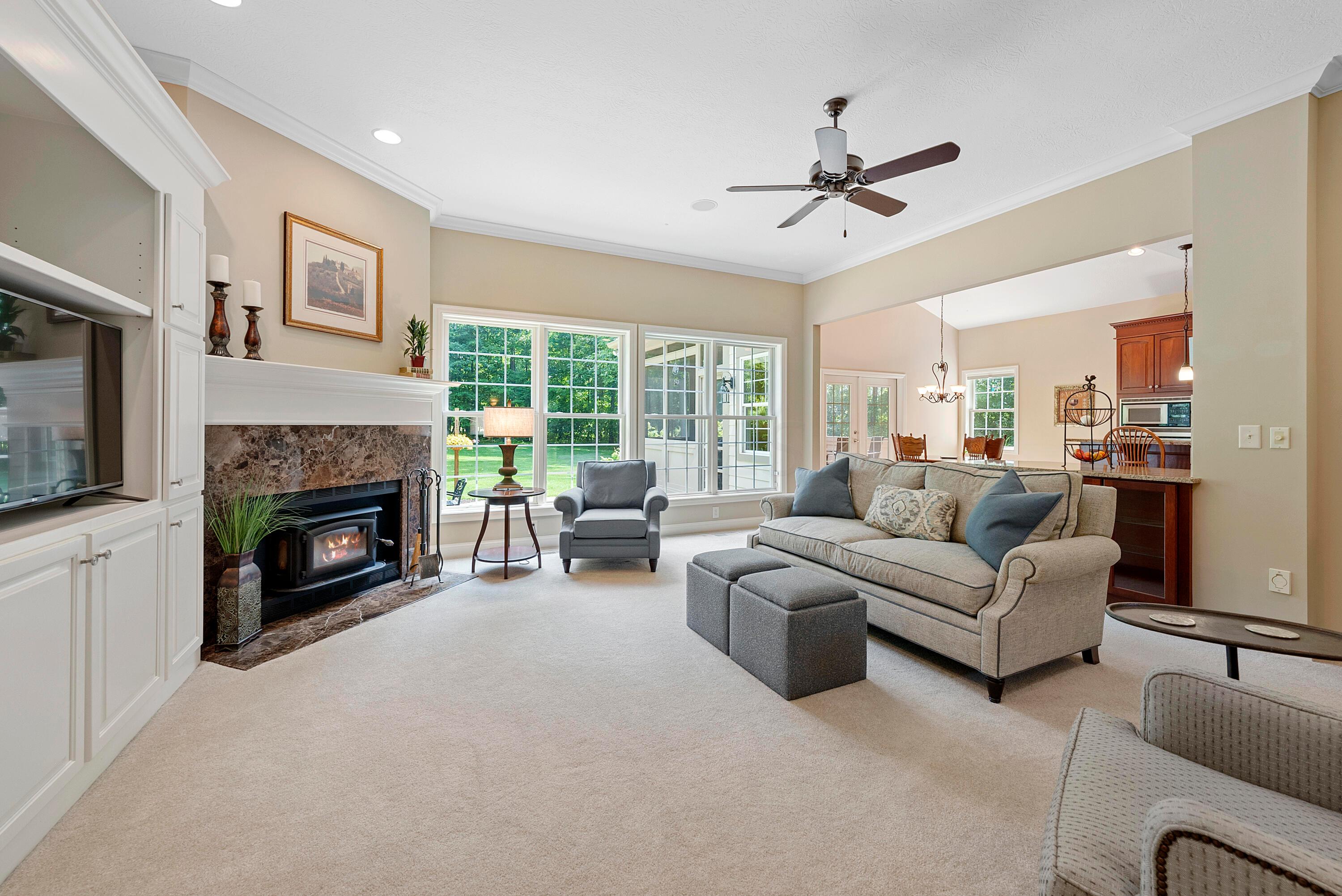 5761 Hughes Road Galena, OH 43021 - Photo 13 of 43 The warm, inviting Great Room is at the heart of the home and is highlighted by a wall of windows, offering beautiful views of the wooded property & filling the room with natural light