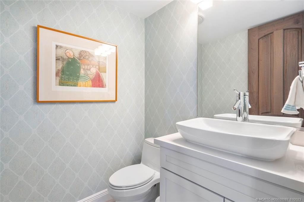 2160 Golfview Lane Stuart, FL 34996 - Photo 21 of 97 a bathroom with a toilet a sink and a mirror