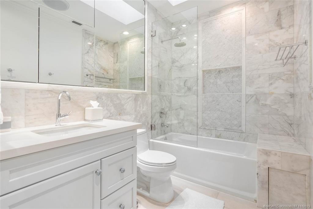 2160 Golfview Lane Stuart, FL 34996 - Photo 27 of 97 a bathroom with a granite countertop sink a toilet and shower