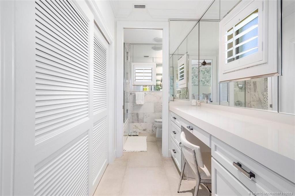 2160 Golfview Lane Stuart, FL 34996 - Photo 43 of 97 a bathroom with a granite countertop sink a mirror and a shower