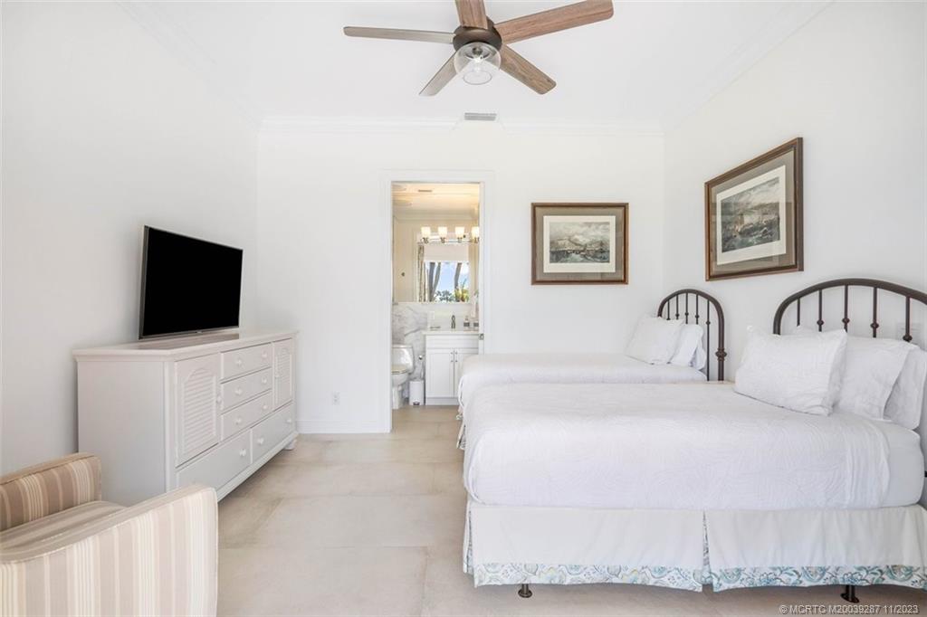 2160 Golfview Lane Stuart, FL 34996 - Photo 45 of 97 a bedroom with a bed and a flat screen tv