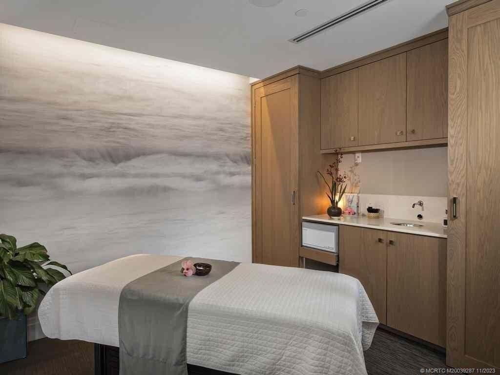 2160 Golfview Lane Stuart, FL 34996 - Photo 92 of 97 a bedroom with a bed and a cabinets