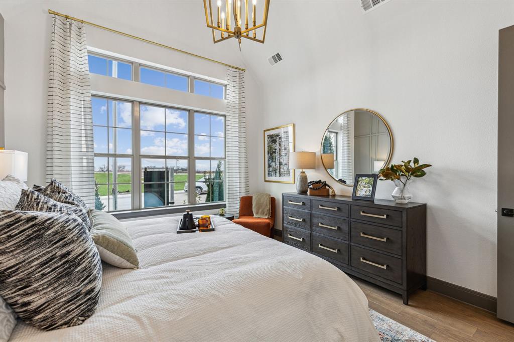 2078 Cuellar Way Van Alstyne, TX 75495 - Photo 11 of 30 a bedroom with a bed and large windows