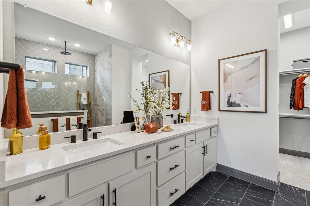 2078 Cuellar Way Van Alstyne, TX 75495 - Photo 12 of 30 a bathroom with double vanity sink a mirror a and a shower