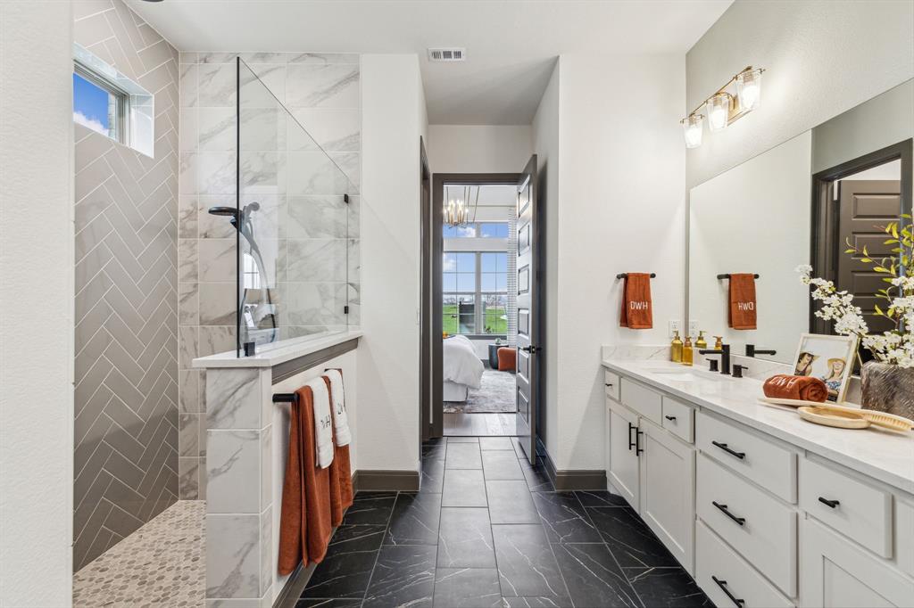 2078 Cuellar Way Van Alstyne, TX 75495 - Photo 14 of 30 a large bathroom with a double vanity sink a mirror and a shower