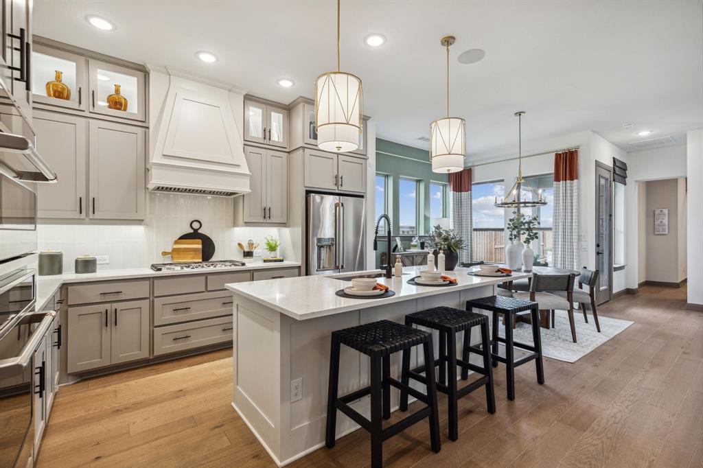 2078 Cuellar Way Van Alstyne, TX 75495 - Photo 17 of 30 a kitchen with stainless steel appliances granite countertop a sink a stove a table and chairs
