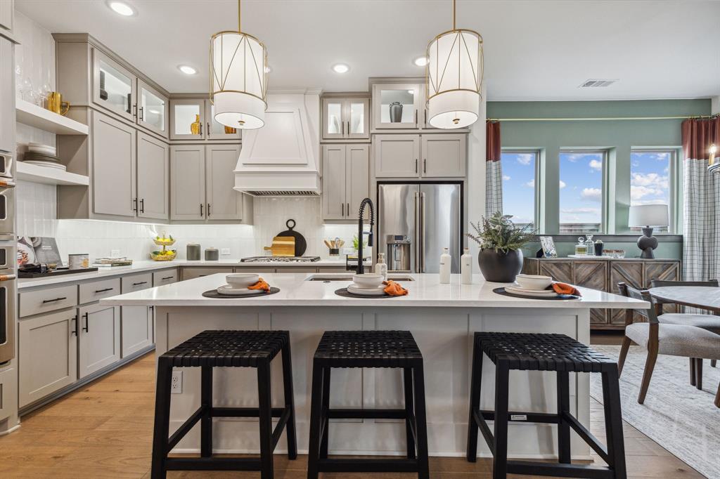 2078 Cuellar Way Van Alstyne, TX 75495 - Photo 18 of 30 a kitchen with stainless steel appliances granite countertop a sink a stove a refrigerator and island