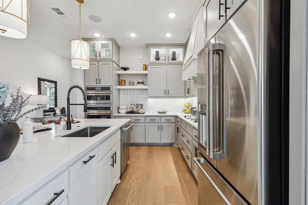 2078 Cuellar Way Van Alstyne, TX 75495 - Photo 20 of 30 a kitchen with stainless steel appliances granite countertop a sink refrigerator and cabinets