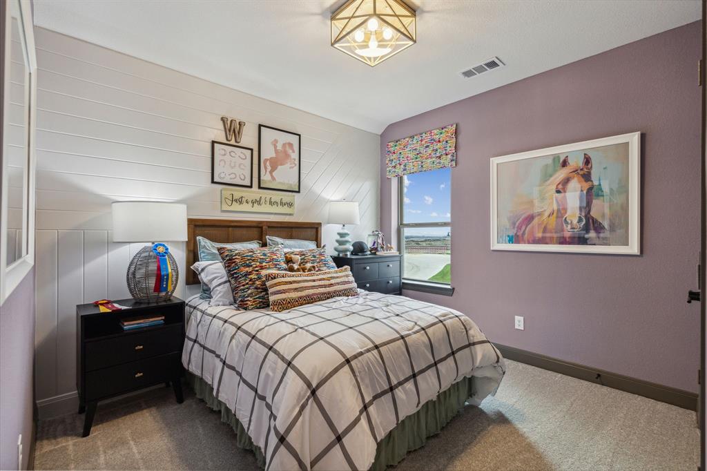 2078 Cuellar Way Van Alstyne, TX 75495 - Photo 29 of 30 a bedroom with a bed and a painting on the wall