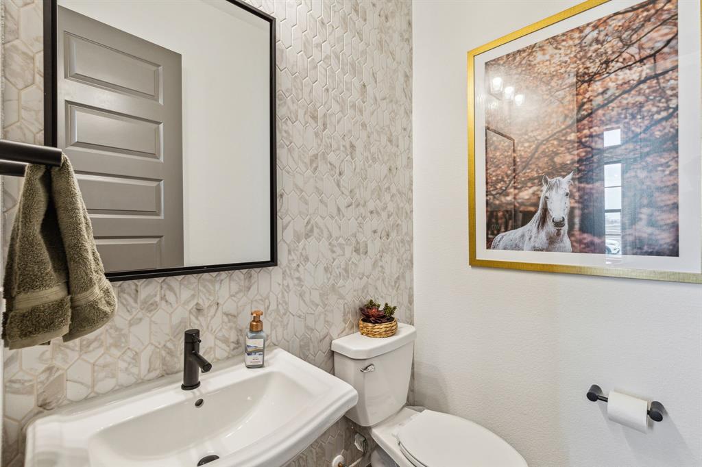2078 Cuellar Way Van Alstyne, TX 75495 - Photo 8 of 30 a bathroom with a sink and mirror with toilet