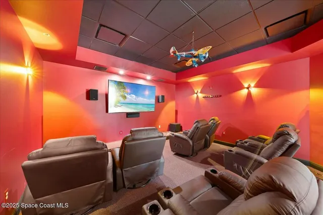 a view of a dining room with furniture and a chandelier