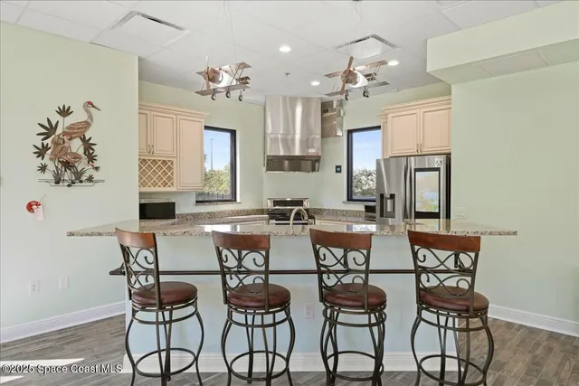 a dining room with furniture window and wooden floor