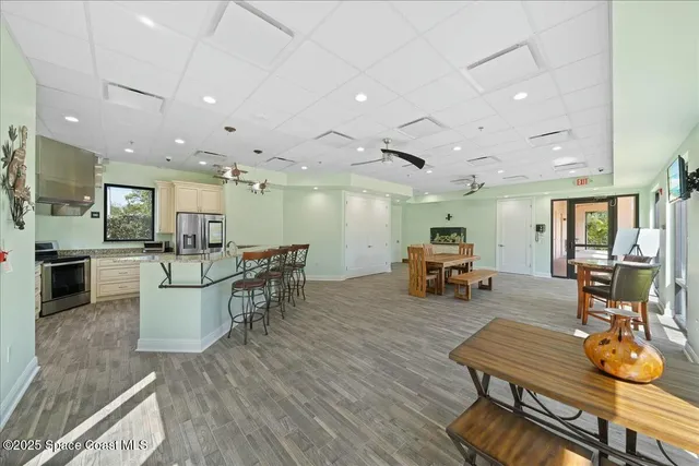 a large kitchen with a refrigerator a stove top oven a sink and dishwasher