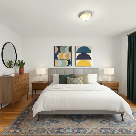 a bedroom with a bed and a painting on the wall