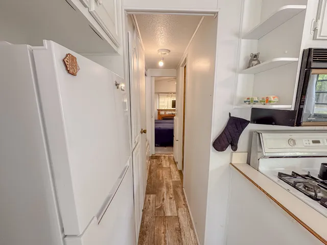 a view of a kitchen from a hallway