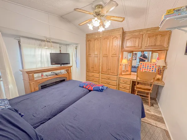 a bedroom with furniture and a flat screen tv