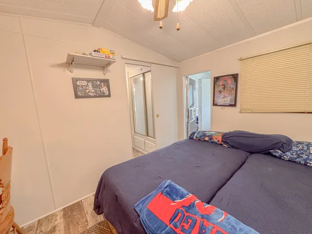 a bedroom with a bed and a painting on the wall