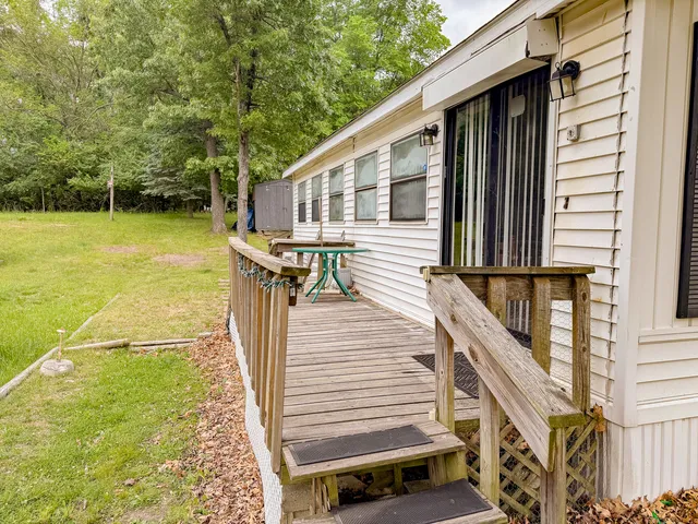 a view of a patio with chairs next to a yard