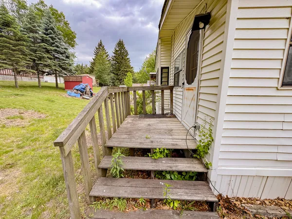 a view of balcony with wooden floor and outdoor seating
