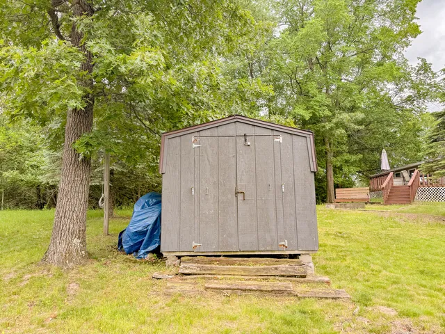 a backyard of a house with table and chairs