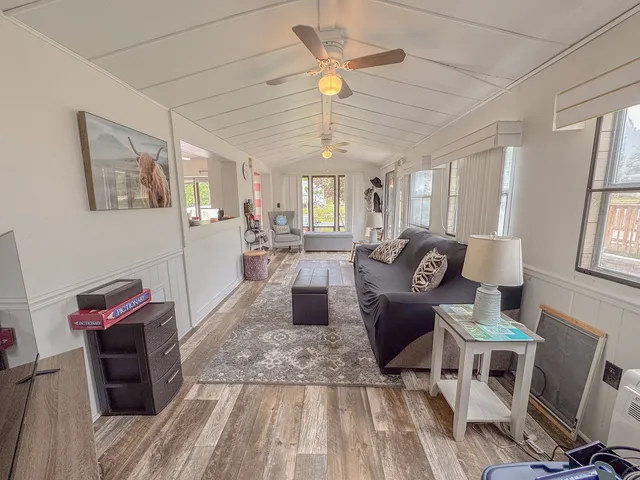 a living room with furniture a window and a chandelier