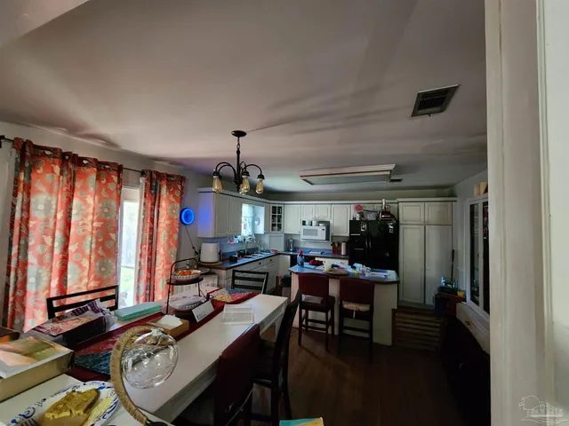 a view of a workspace with furniture and window