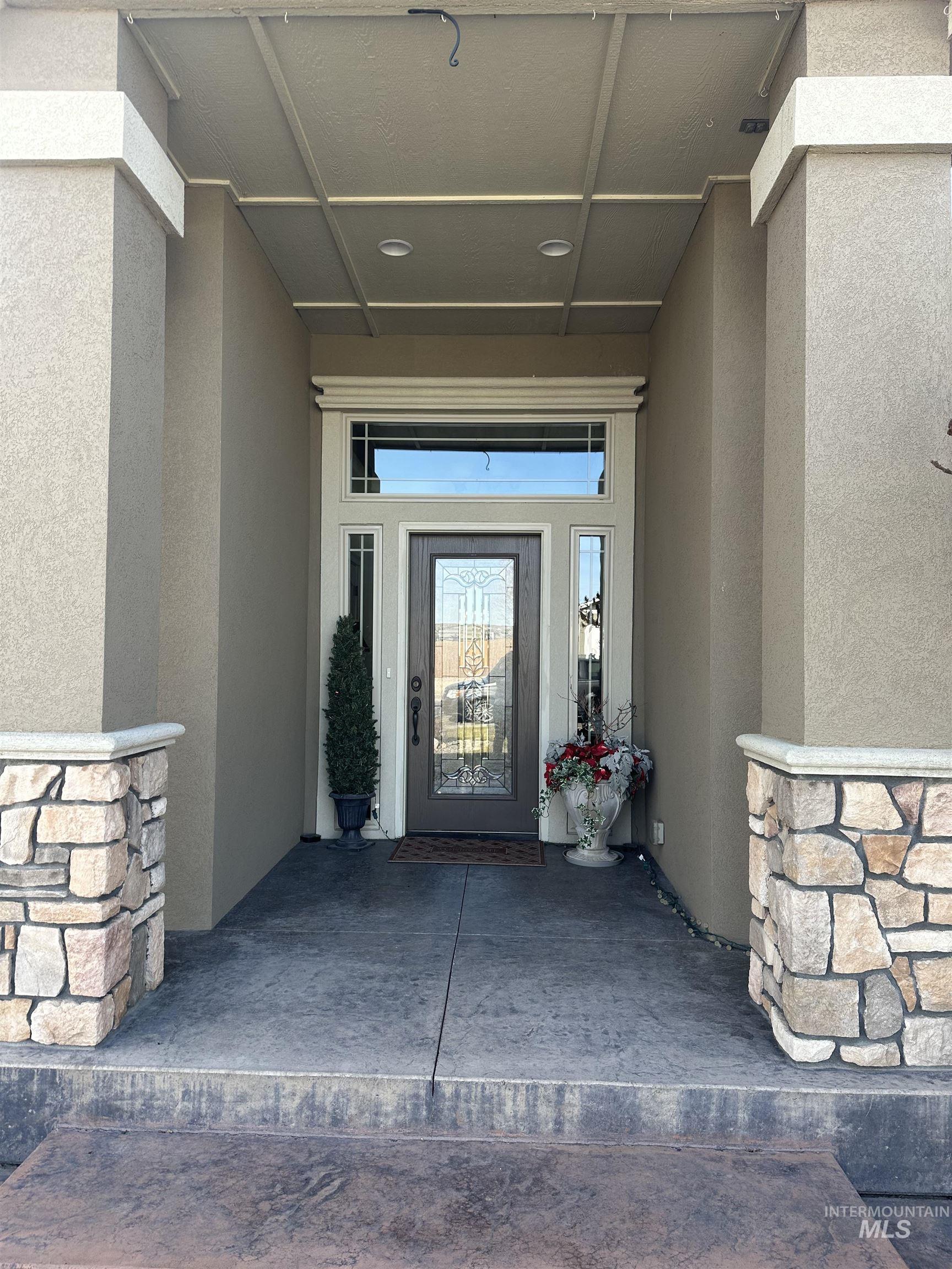235 Northeast Greystone Loop Mountain Home, ID 83647 - Photo 4 of 5 Doorway to property with stucco siding and stone siding