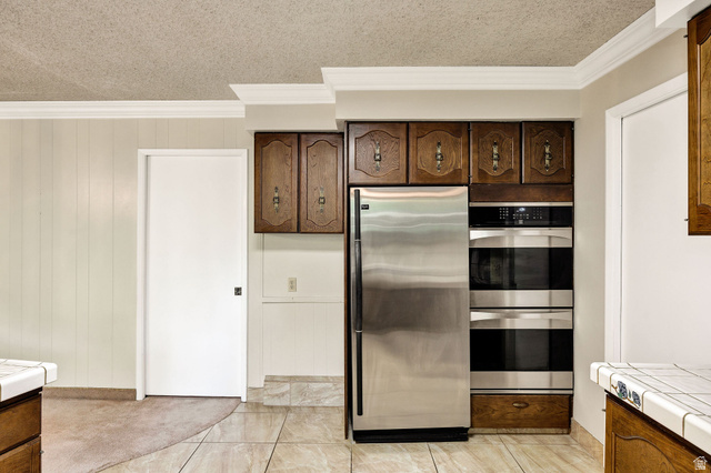 1365 Sumac Drive Logan, UT 84321 - Photo 20 of 66 Kitchen area featuring stainless steel refrigerator, double wall ovens, wood cabinetry, and tile flooring