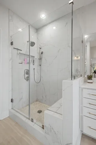 a spacious bathroom with a shower tub sink and mirror