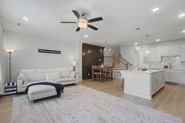a living room with furniture and kitchen view