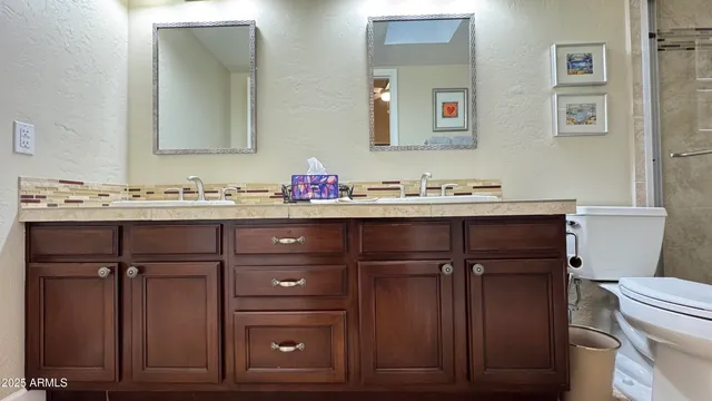 a bathroom with a sink vanity and a toilet