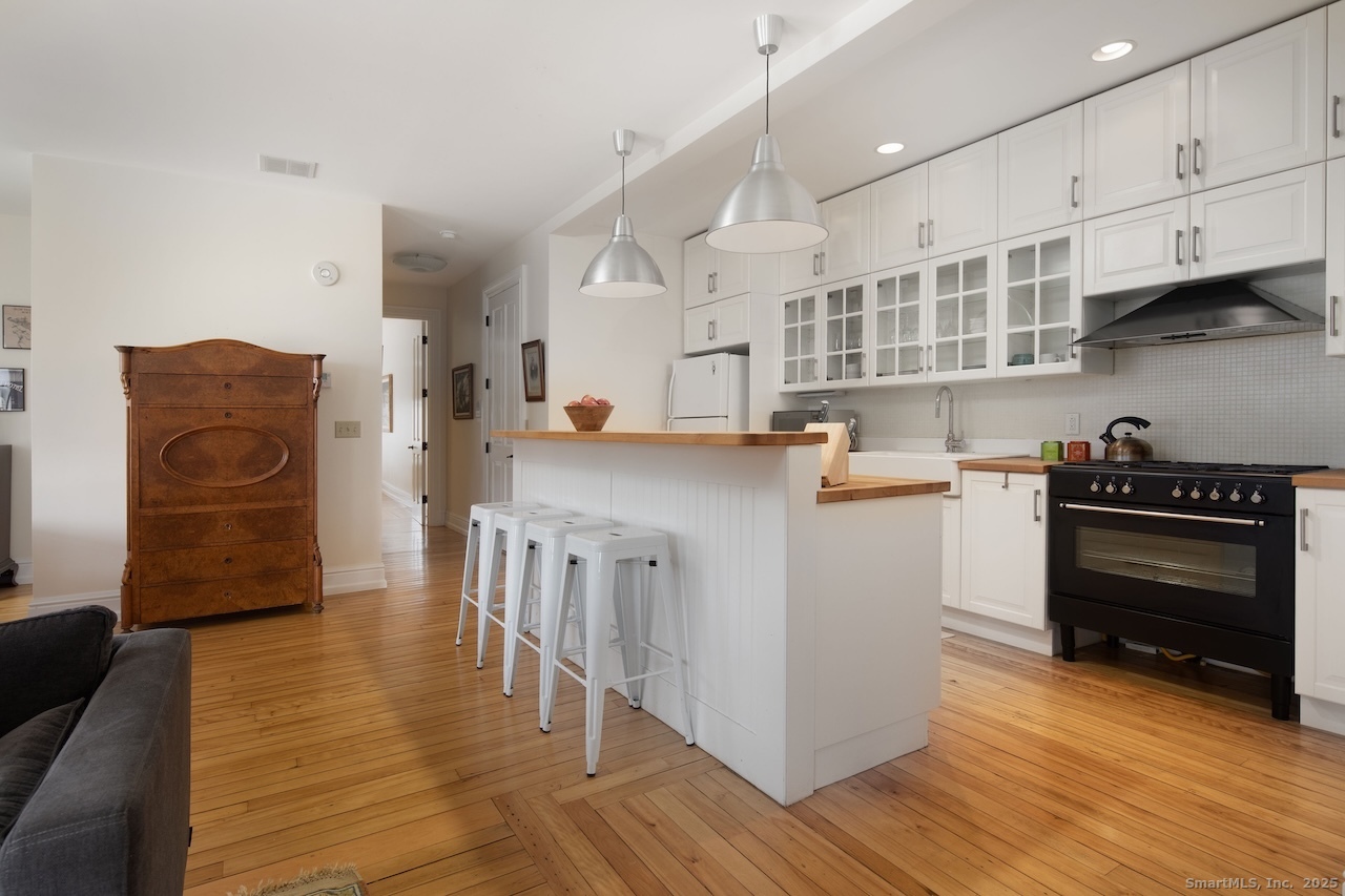 31 Sharon Road, Unit 4 Salisbury, CT 06039 - Photo 3 of 16 a kitchen with stainless steel appliances granite countertop a refrigerator a stove and a wooden floors