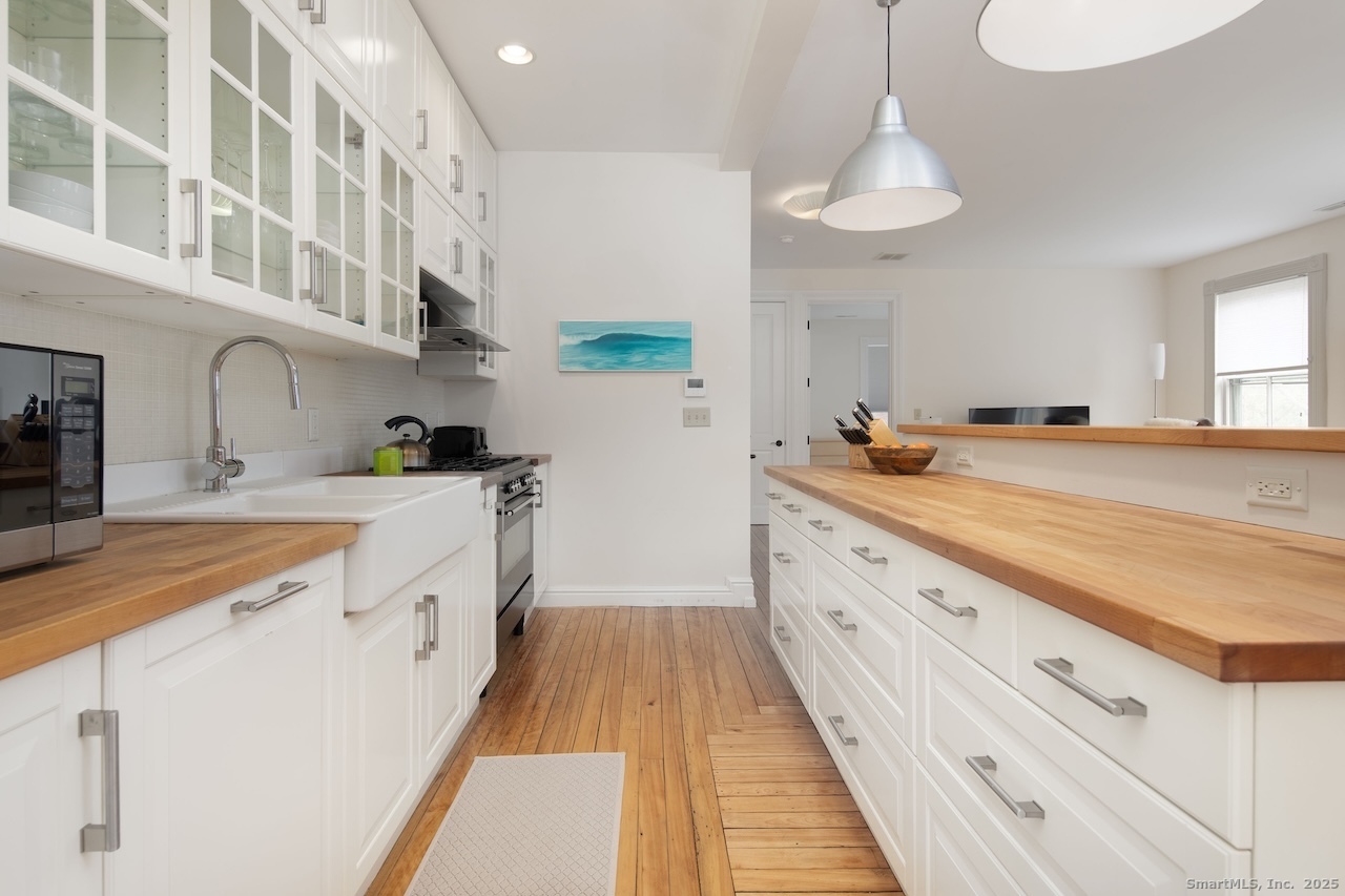 31 Sharon Road, Unit 4 Salisbury, CT 06039 - Photo 4 of 16 a large kitchen with a sink and cabinets