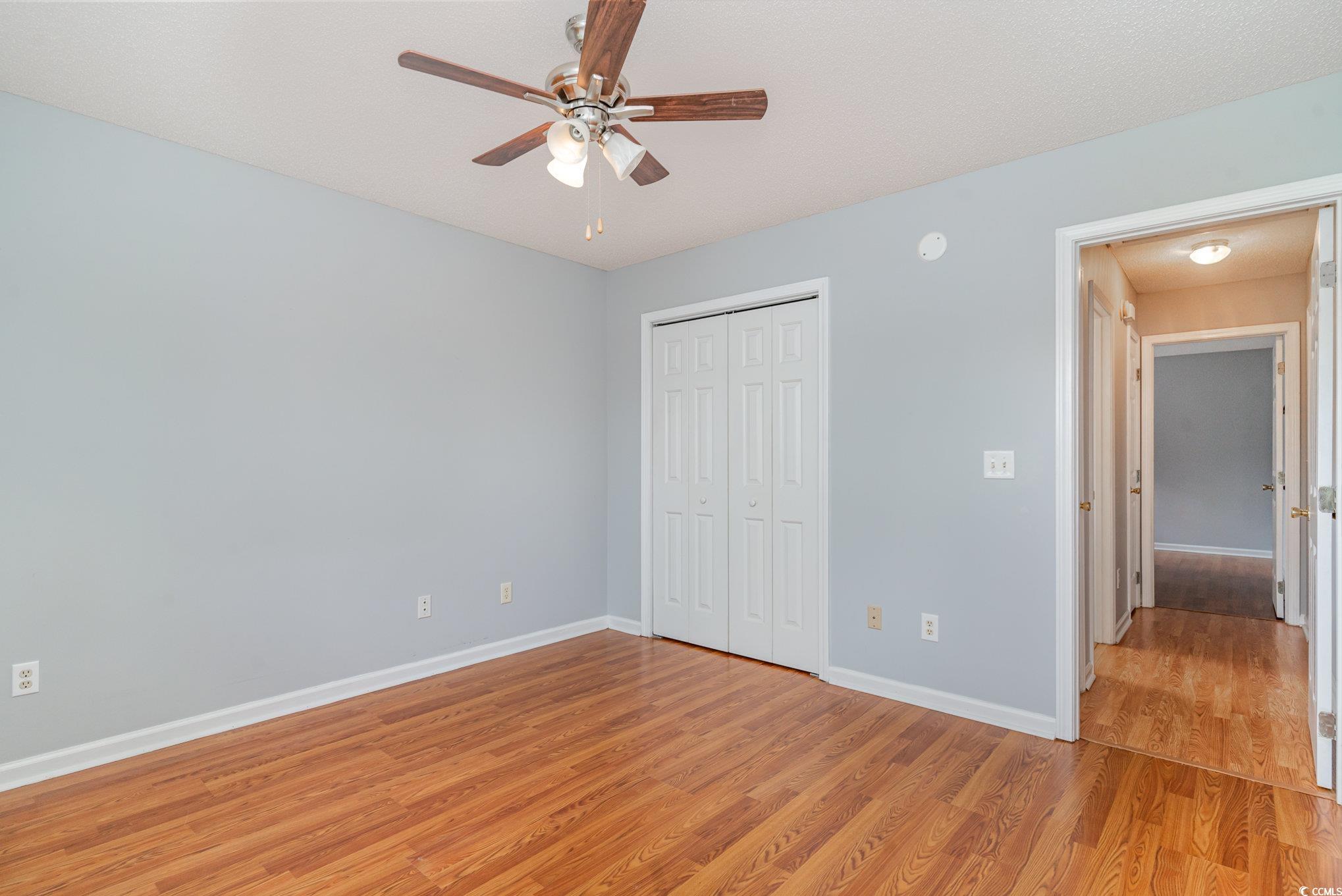 209 Kestrel Court Myrtle Beach, SC 29588 - Photo 14 of 27 Unfurnished bedroom with ceiling fan, light hardwo
