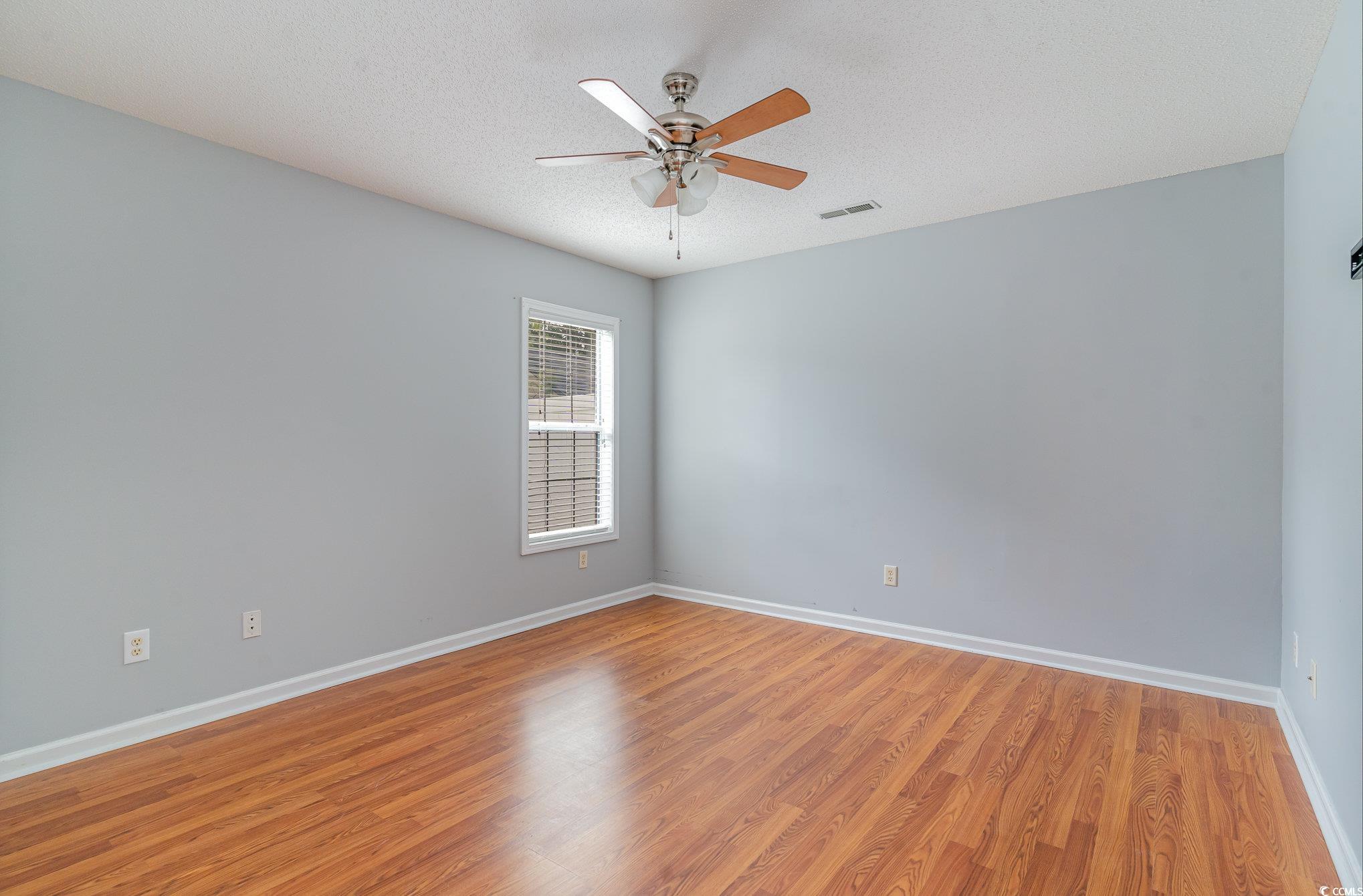 209 Kestrel Court Myrtle Beach, SC 29588 - Photo 16 of 27 Spare room featuring ceiling fan, a textured ceili