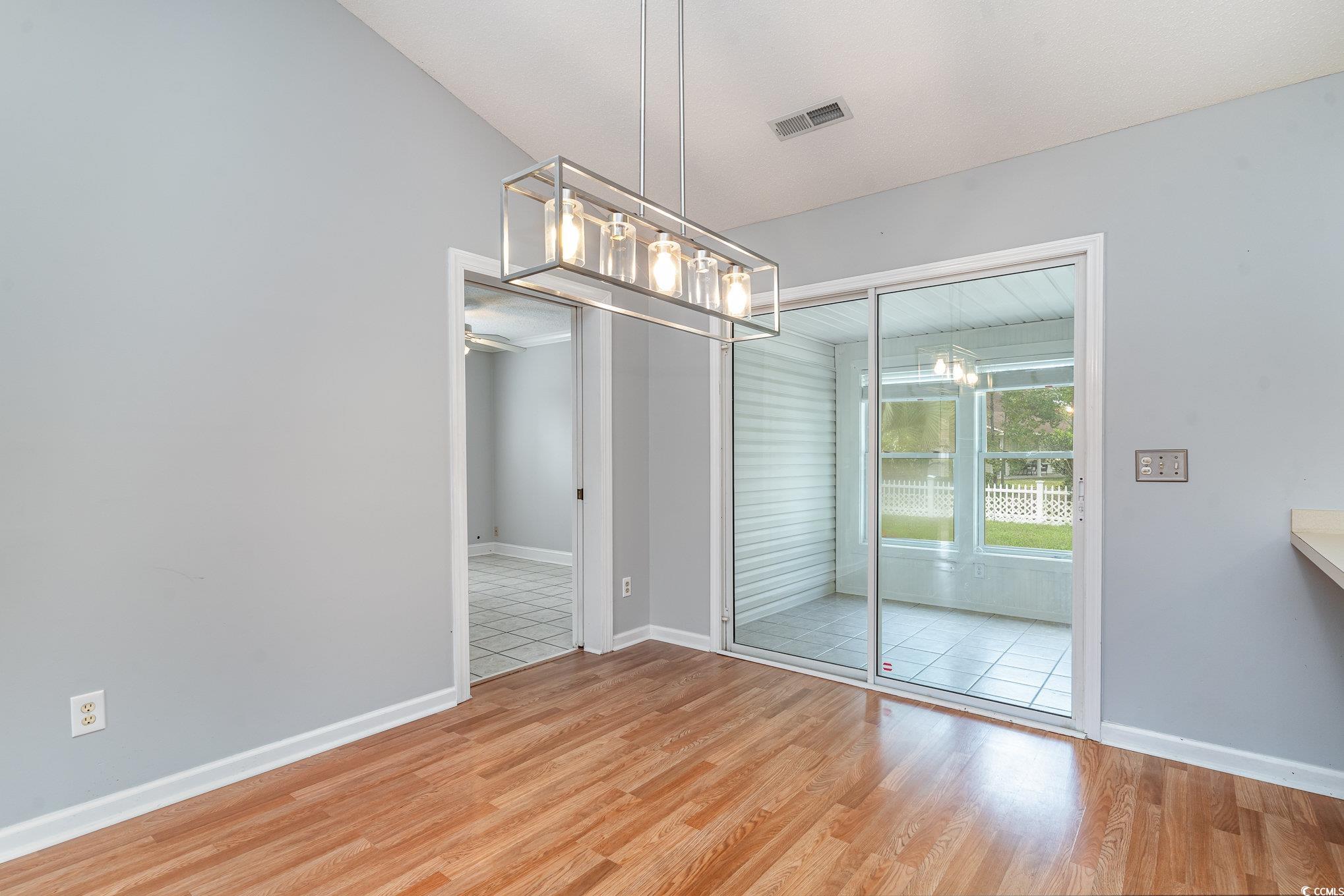 209 Kestrel Court Myrtle Beach, SC 29588 - Photo 6 of 27 Unfurnished dining area featuring hardwood / wood-
