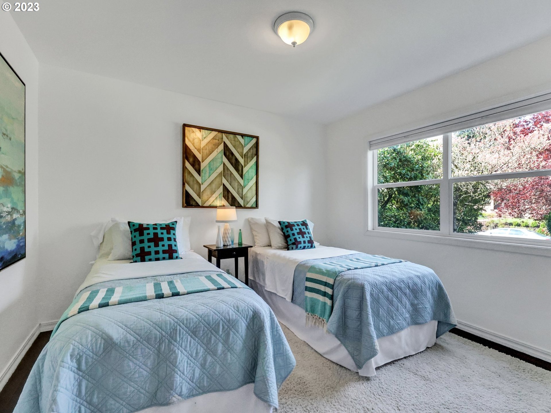 5606 Northeast 27th Avenue Portland, OR 97211 - Photo 19 of 48 a bedroom with two beds and a large window