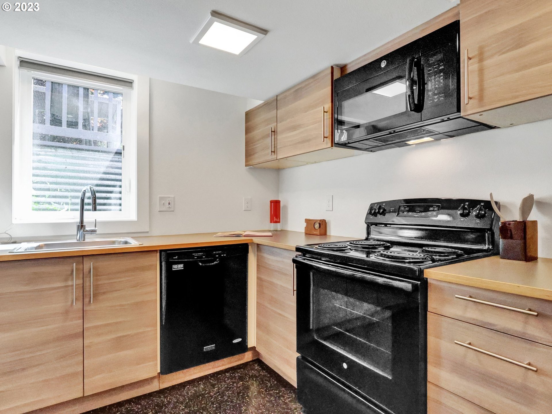 5606 Northeast 27th Avenue Portland, OR 97211 - Photo 41 of 48 a kitchen with stainless steel appliances granite countertop a stove and a microwave