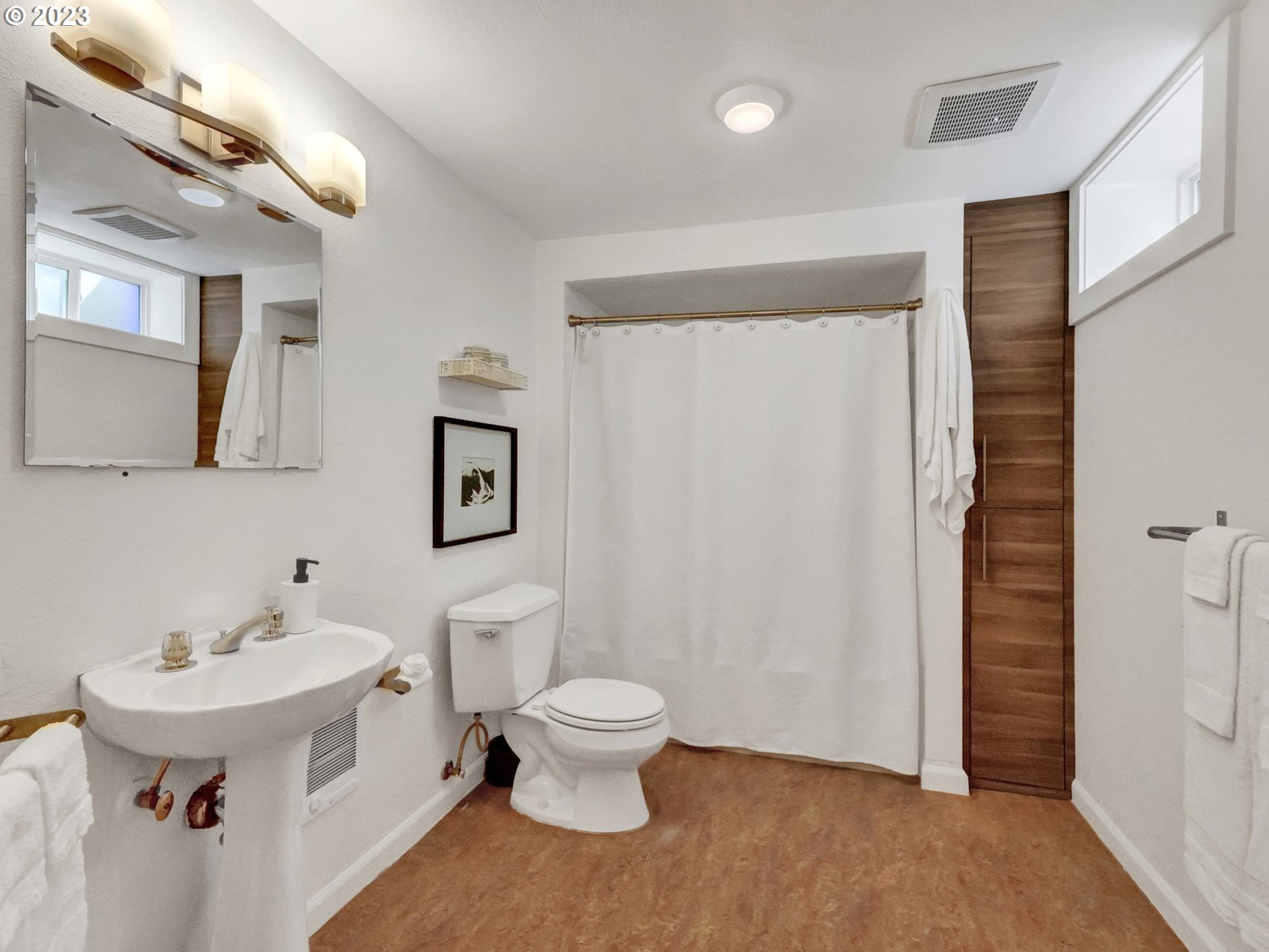 5606 Northeast 27th Avenue Portland, OR 97211 - Photo 46 of 48 a bathroom with a toilet sink and mirror