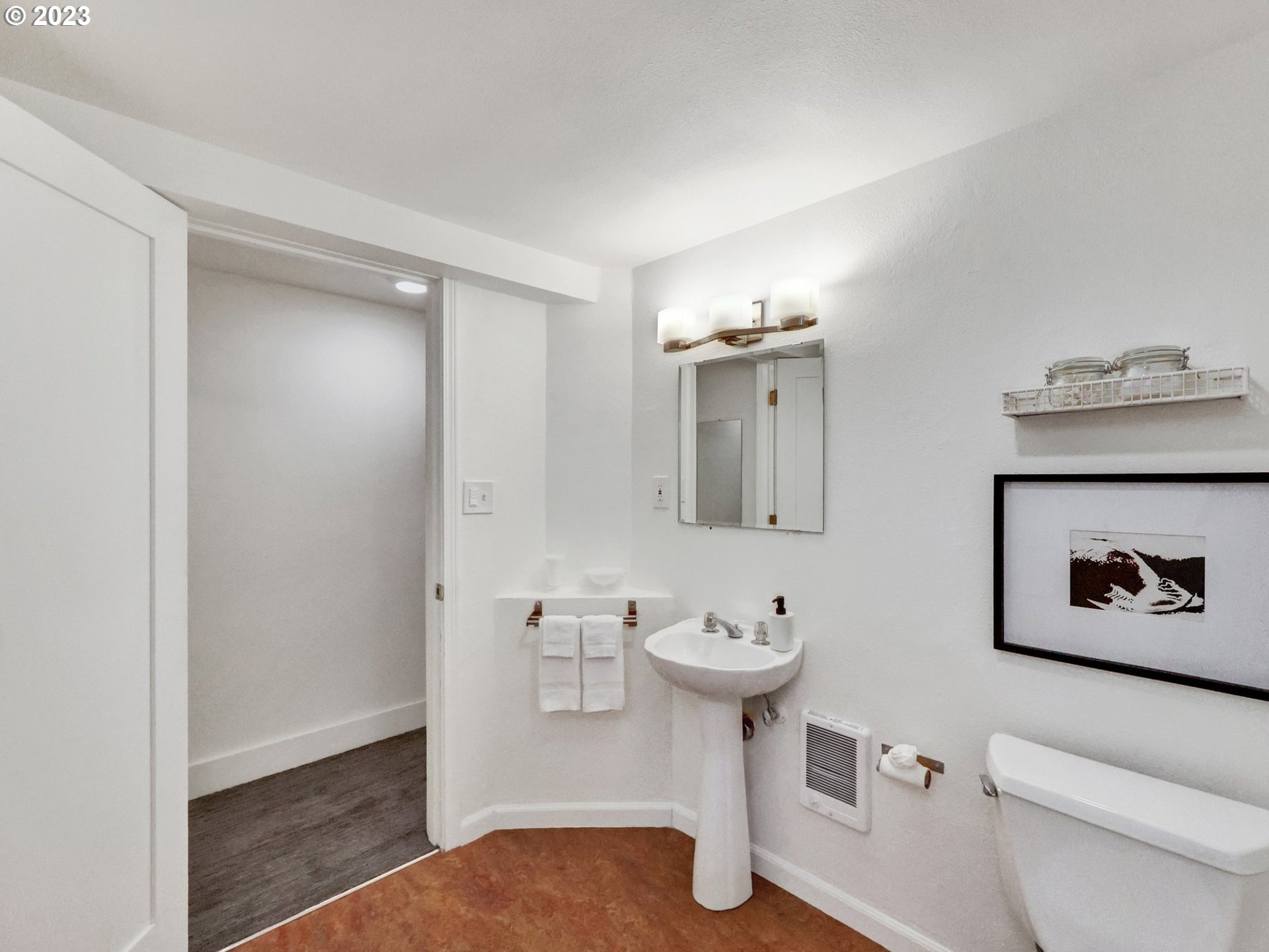 5606 Northeast 27th Avenue Portland, OR 97211 - Photo 47 of 48 a bathroom with a toilet sink and mirror