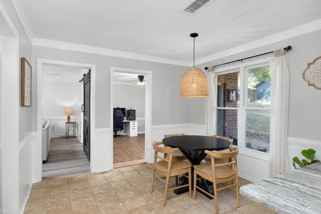 a dining room with furniture and window