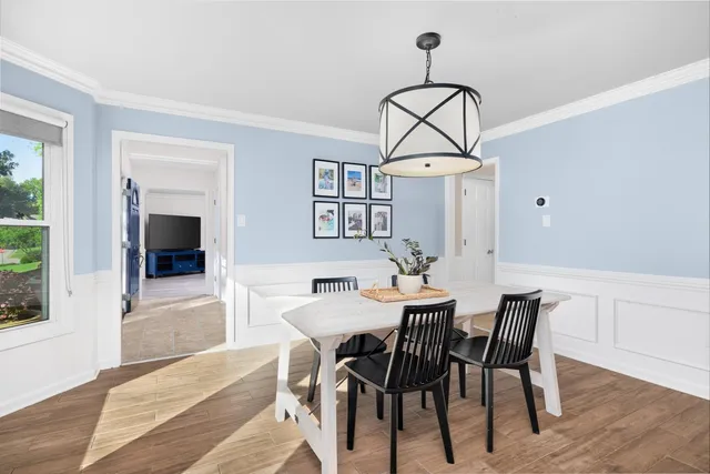a view of a dining room with furniture window and wooden floor