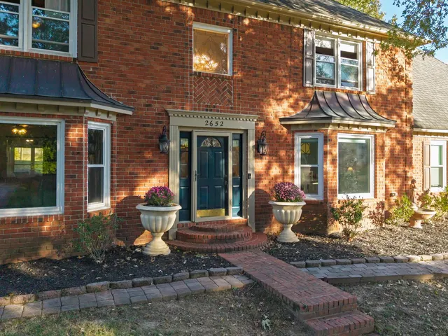 a front view of a house with sitting area