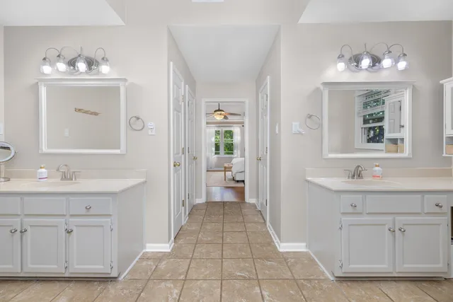 a bathroom with a sink vanity and mirror