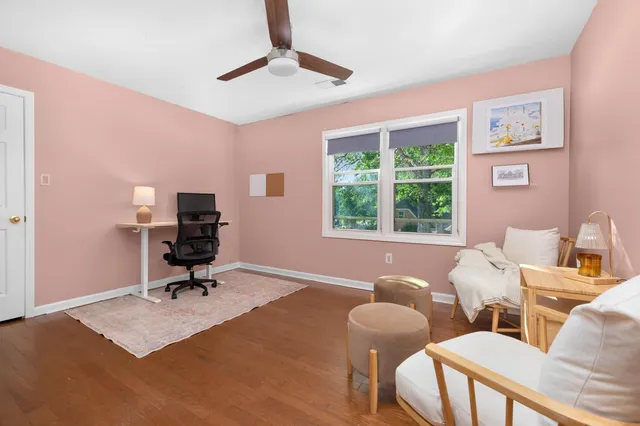 a view of a livingroom with workspace and a window