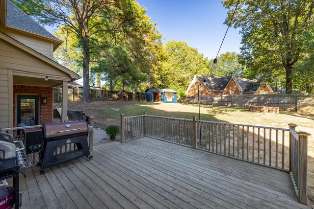 a view of a deck with chairs and wooden fence